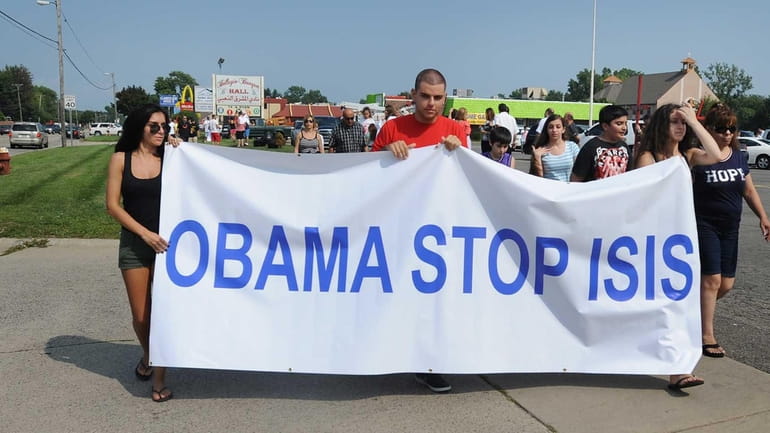 Protestors are seen here calling on President Barack Obama to...