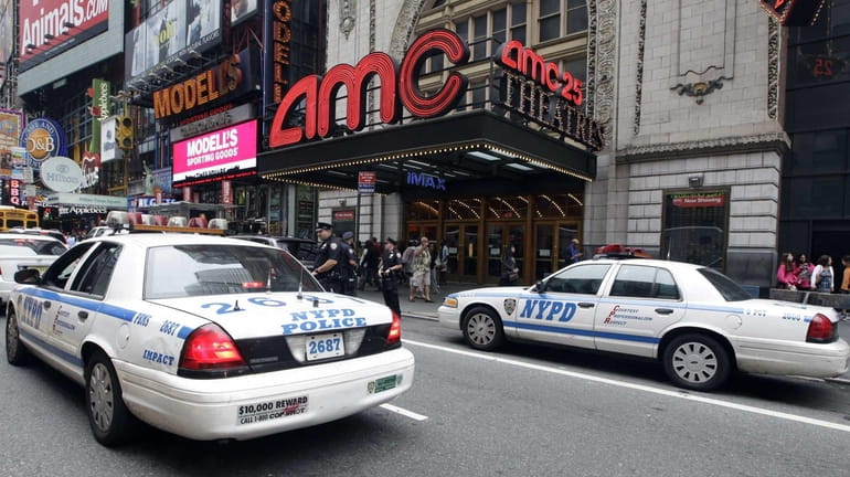 Police officers outside an AMC movie theater screening "The Dark...