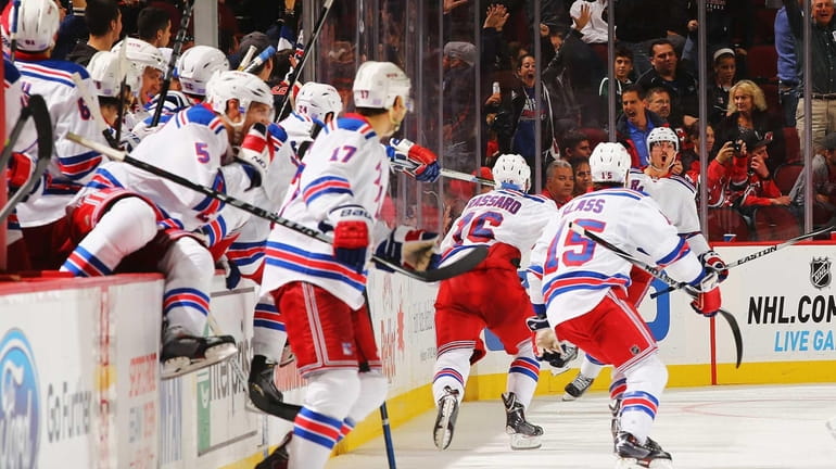 The Rangers celebrate the game-winning overtime goal by Kevin Klein...