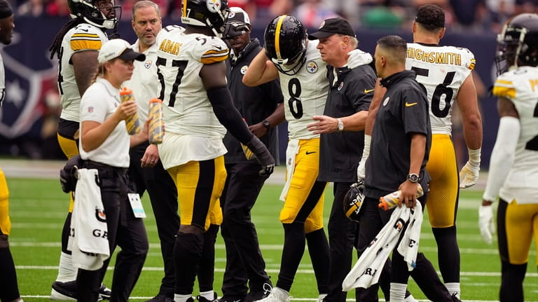 Pittsburgh Steelers quarterback Kenny Pickett (8) is helped off the...