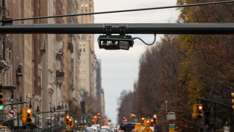 License plate-scanning cameras above traffic in Manhattan.