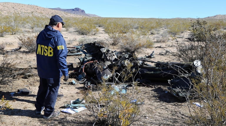 An NTSB investigator surveys the site of an Airbus Helicopters...
