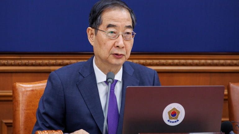 South Korea's Prime Minster Han Duck-soo speaks during a cabinet...