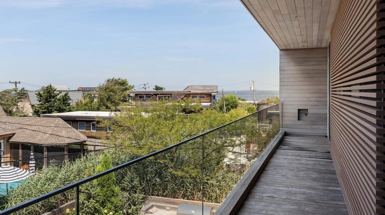 The house has a roof deck with expansive water views.