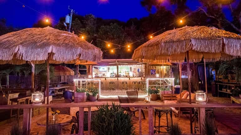 Lynn's Hula Hut, a waterside Tiki bar, is a popular...
