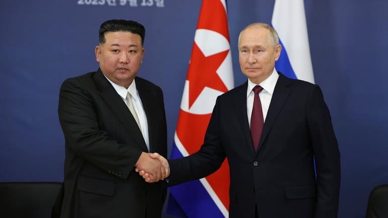 Russian President Vladimir Putin, right, and North Korean leader Kim...