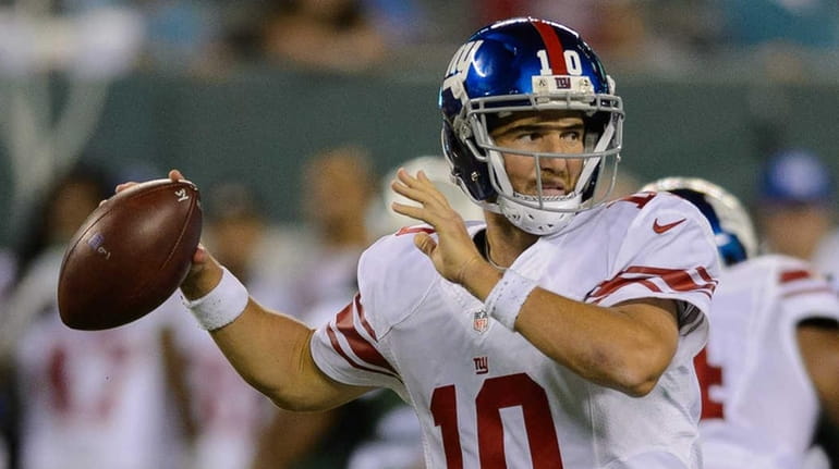 New York Giants quarterback Eli Manning (10) makes a pass...