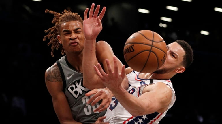 Nicolas Claxton of the Nets fouls Ben Simmons of the 76ers...