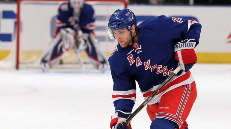 Michael Sauer of the Rangers shoots the puck against the...