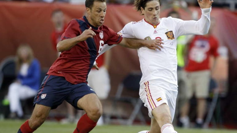 Spain's Fernando Torres, right, shoots and scores despite the defensive...