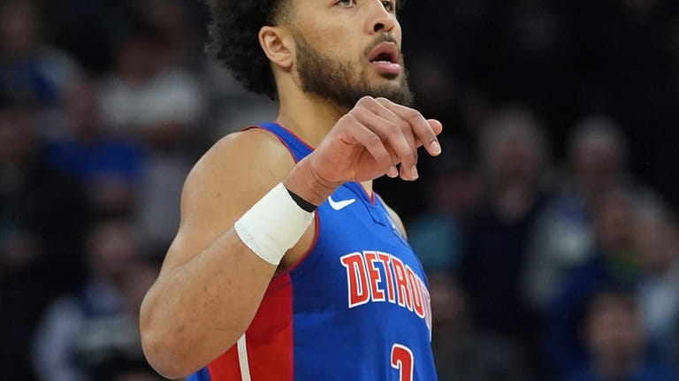Detroit Pistons guard Cade Cunningham looks down the court after...
