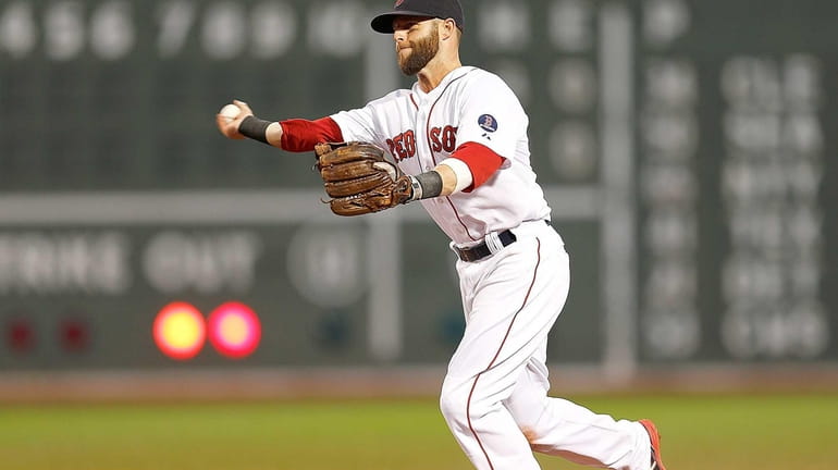 Dustin Pedroia #15 of the Red Sox makes an assist...