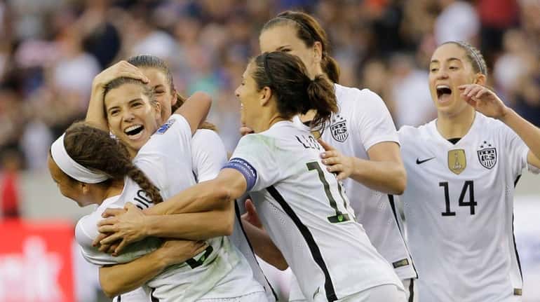 United States Tobin Heath, second from left, celebrates with teammates...