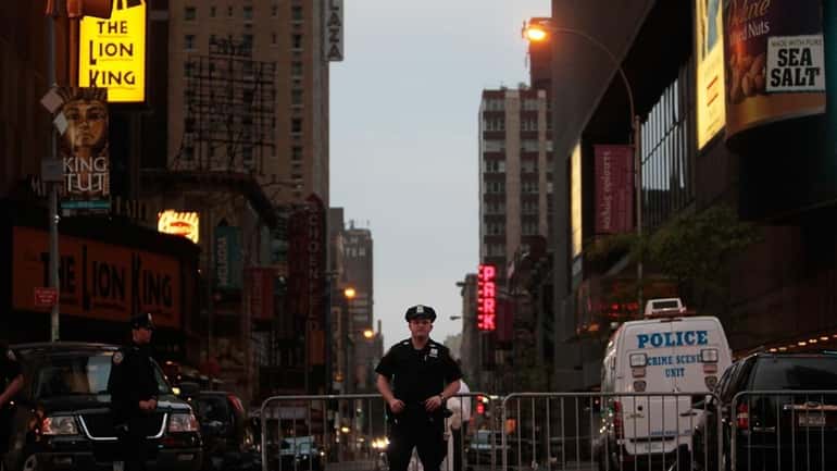 Police stand by at sunrise at the scene where a...