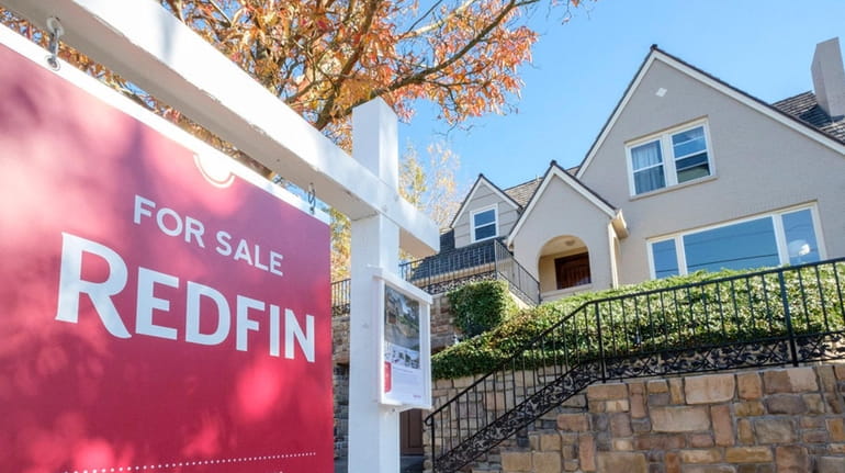 A Redfin yard sign announces a home for sale in...