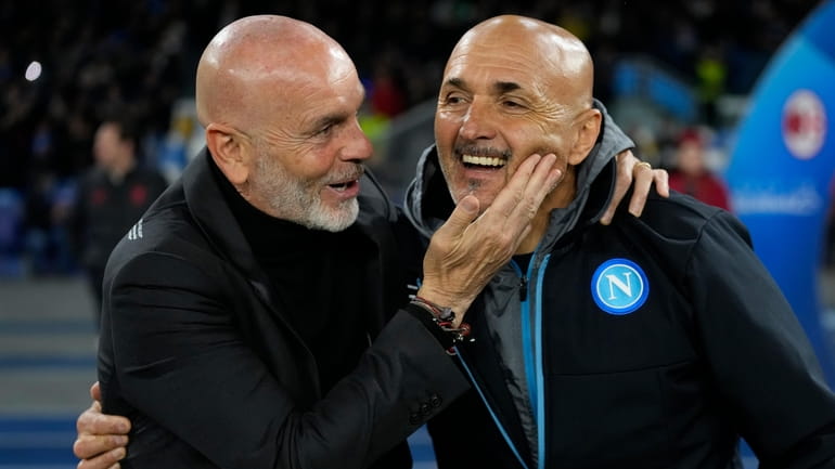 AC Milan's manager Stefano Pioli, left, greets Napoli's head coach...