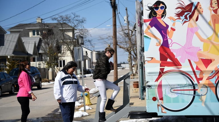 Customers enter Lola's Lookbook, a mobile boutique, parked in Point...