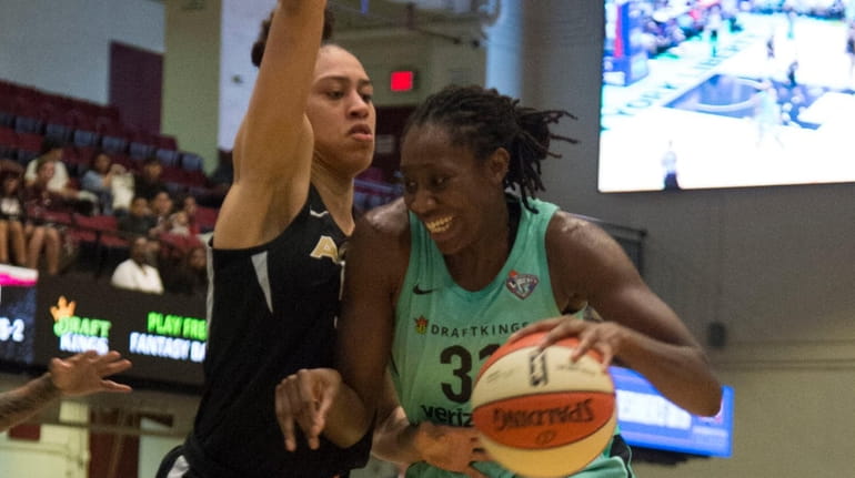 Liberty center Tina Charles tries to drive past the Aces'...