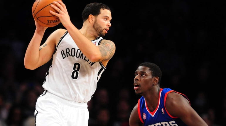 Deron Williams of the Brooklyn Nets is guarded closely by...