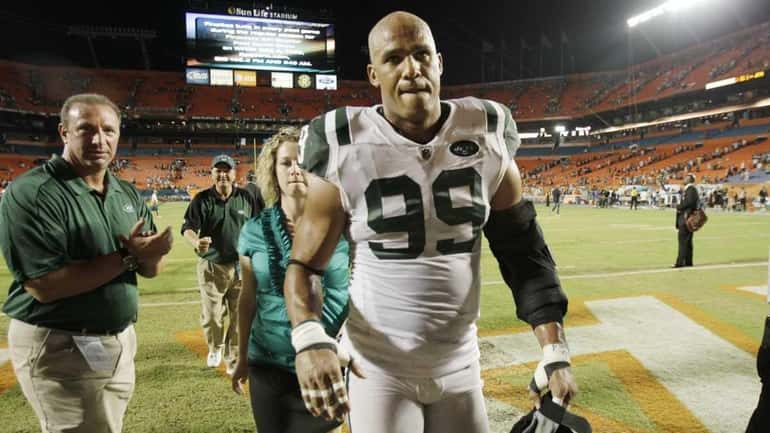 New York Jets linebacker Jason Taylor (99) walks off the...