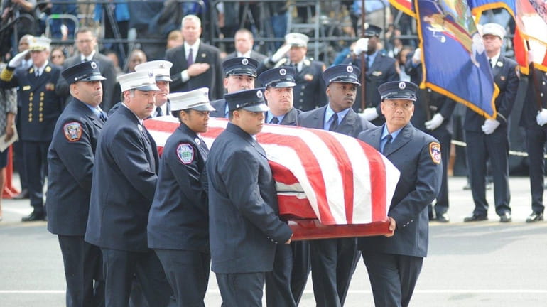 The coffin of FDNY EMT Yadira Arroyo is brought into...