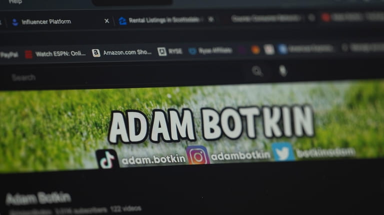 Adam Botkin, a football TikTok influencer, edits a video for...