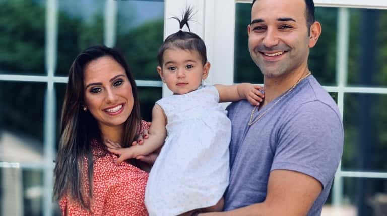 Angela and Rob Calabrese of Bayport with their 14-month-old daughter, Alessia.