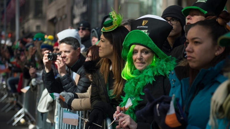 Spectators watch the St. Patrick's Day Parade on Manhattan's Fifth...