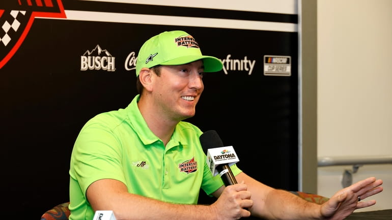 Kyle Busch answers a question from a reporter during a...
