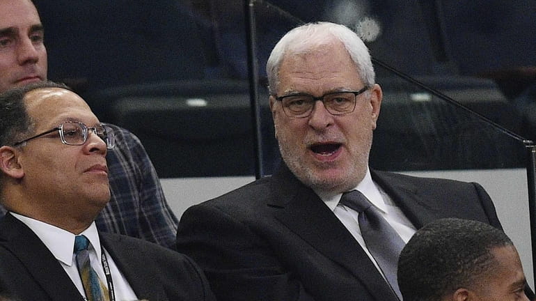 Phil Jackson, right, attends a game between the New York...