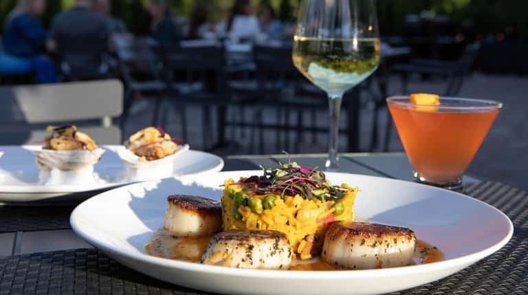 Seared diver sea scallops on the patio at Hooks & Chops...
