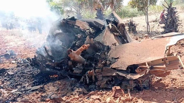 The smoking wreckage of the jet fighter that crashed in...
