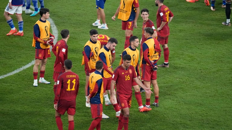 Spain players react after the World Cup group E soccer...