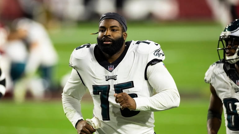 Vinny Curry walks off the field during an NFL game...