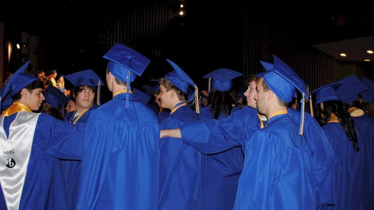 Members of the Class of 2011 take their seats during...