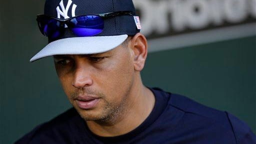 Alex Rodriguez walks in the dugout during a game against...