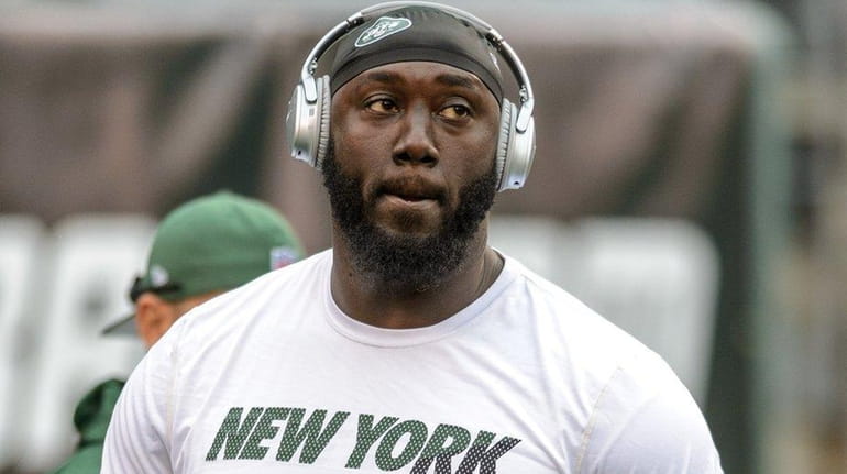 New York Jets defensive end Muhammad Wilkerson looks on before...