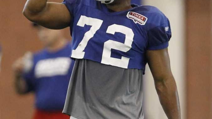 Giants defensive end Osi Umenyiora gestures during a drill as...