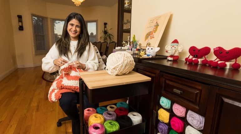 Pooja Hathiramani, 34, poses for a portrait amongst her yarn...