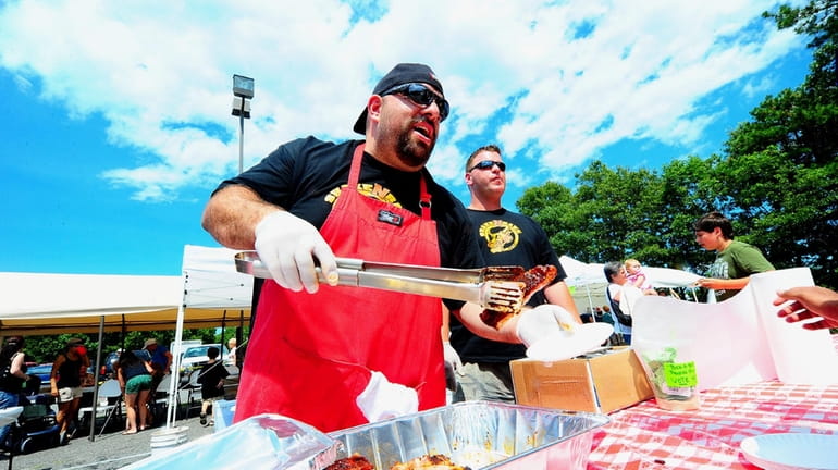 Rocco Camastro of Shake n Bake ribs serves pork ribs...