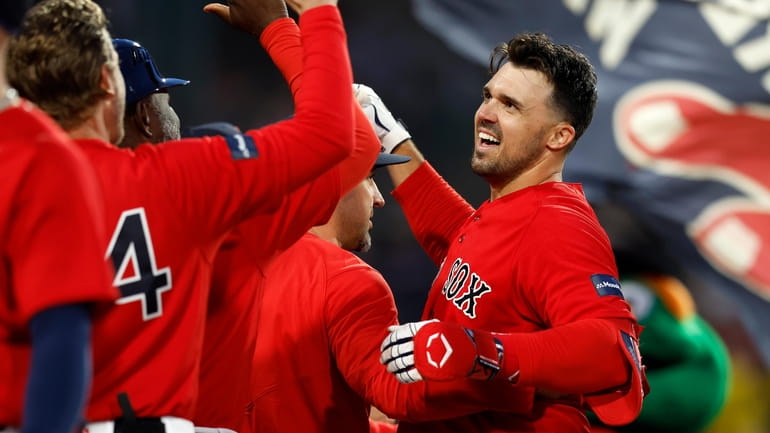 Boston Red Sox's Adam Duvall, right, celebrates teammates after his...