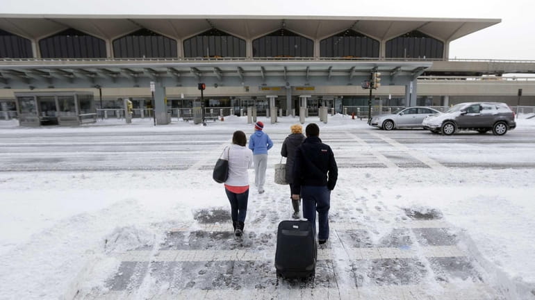 Travelers arrive at Newark Liberty International Airport in Newark. (Jan....