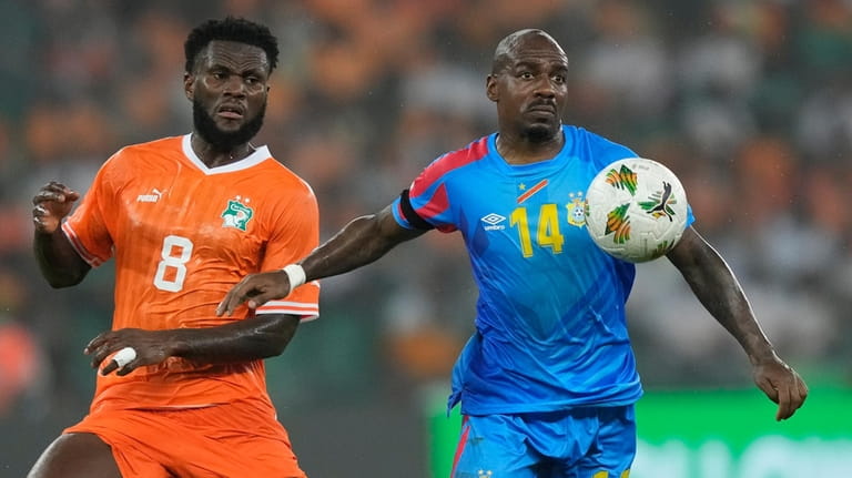 DR Congo's Gael Kakuta, right, holds off Ivory Coast's Franck...
