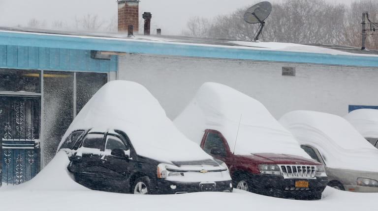 Snowdrifts pile up on top of cars at Argyle Auto...