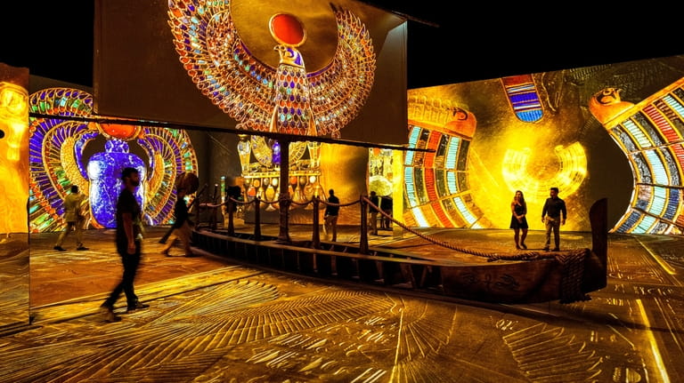 Patrons explore "Beyond King Tut," an immersive experience based on...