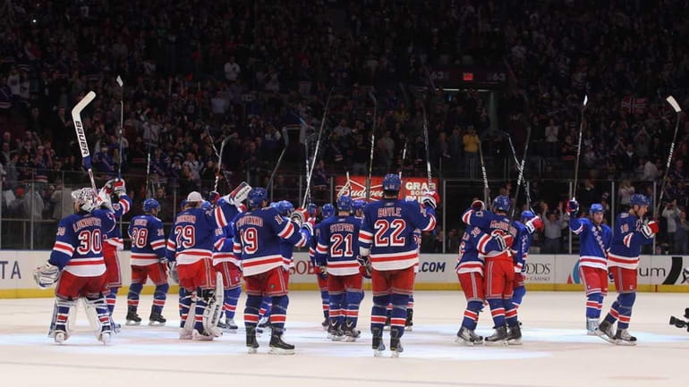 The Rangers celebrate their 5-2 win over the Devils at...