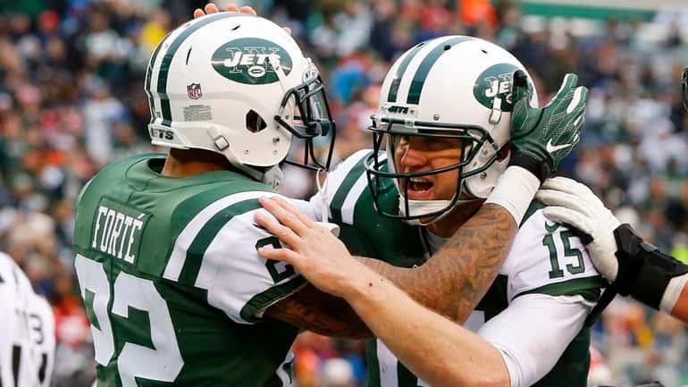The Jets' Matt Forte and Josh McCown celebrate after combining...