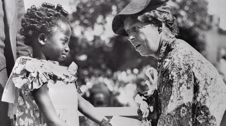 First Lady Eleanor Roosevelt with a young girl in 1935....