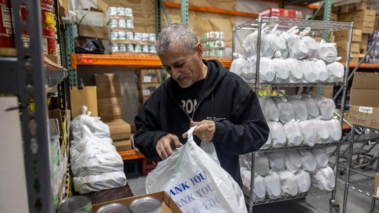 Eddie Gomez, an employee at Pronto food pantry in Brentwood,...