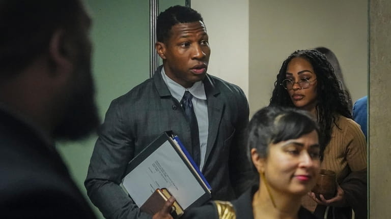 Actor Jonathan Majors, center, arrives at court for his domestic...